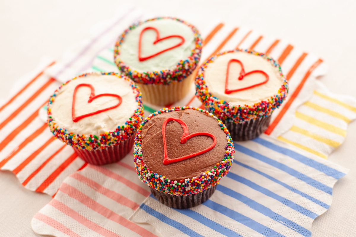 SusieCakes' limited-edition Pride Month Cupcake Box features rainbow sprinkles and heart-topped cupcakes. | Photo by Susie Cakes