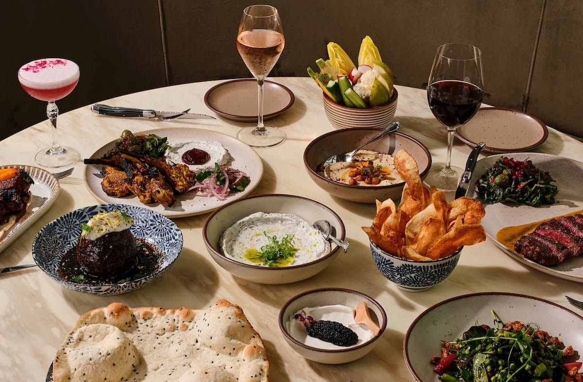 Persian-inspired spreads, house-baked bread, grilled meats, and vibrant mezze define the shareable menu at Delbar. | Photo by Delbar
