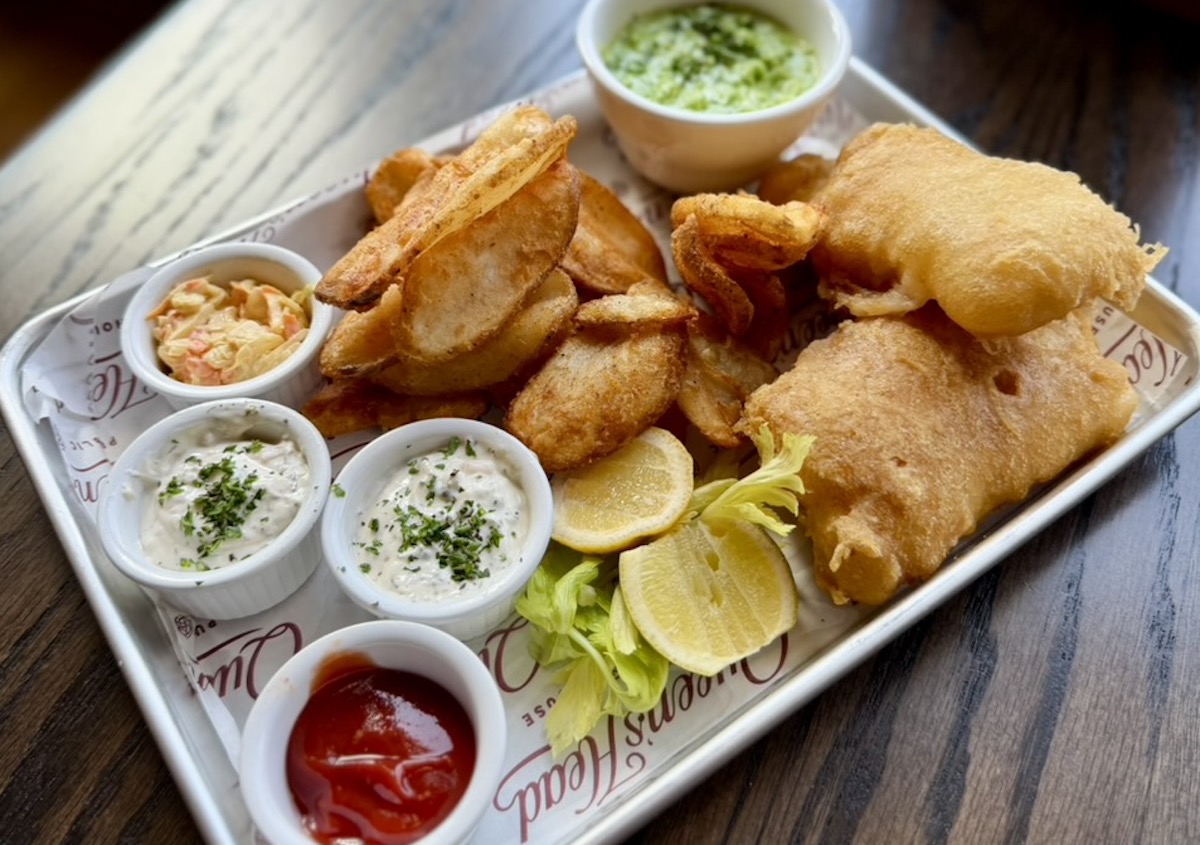 Queen’s Head Pub’s fish and chips features beer-battered cod served with thick-cut chips, housemade tartar sauce, coleslaw, and mushy peas. | Photo by Queen's Head Pub