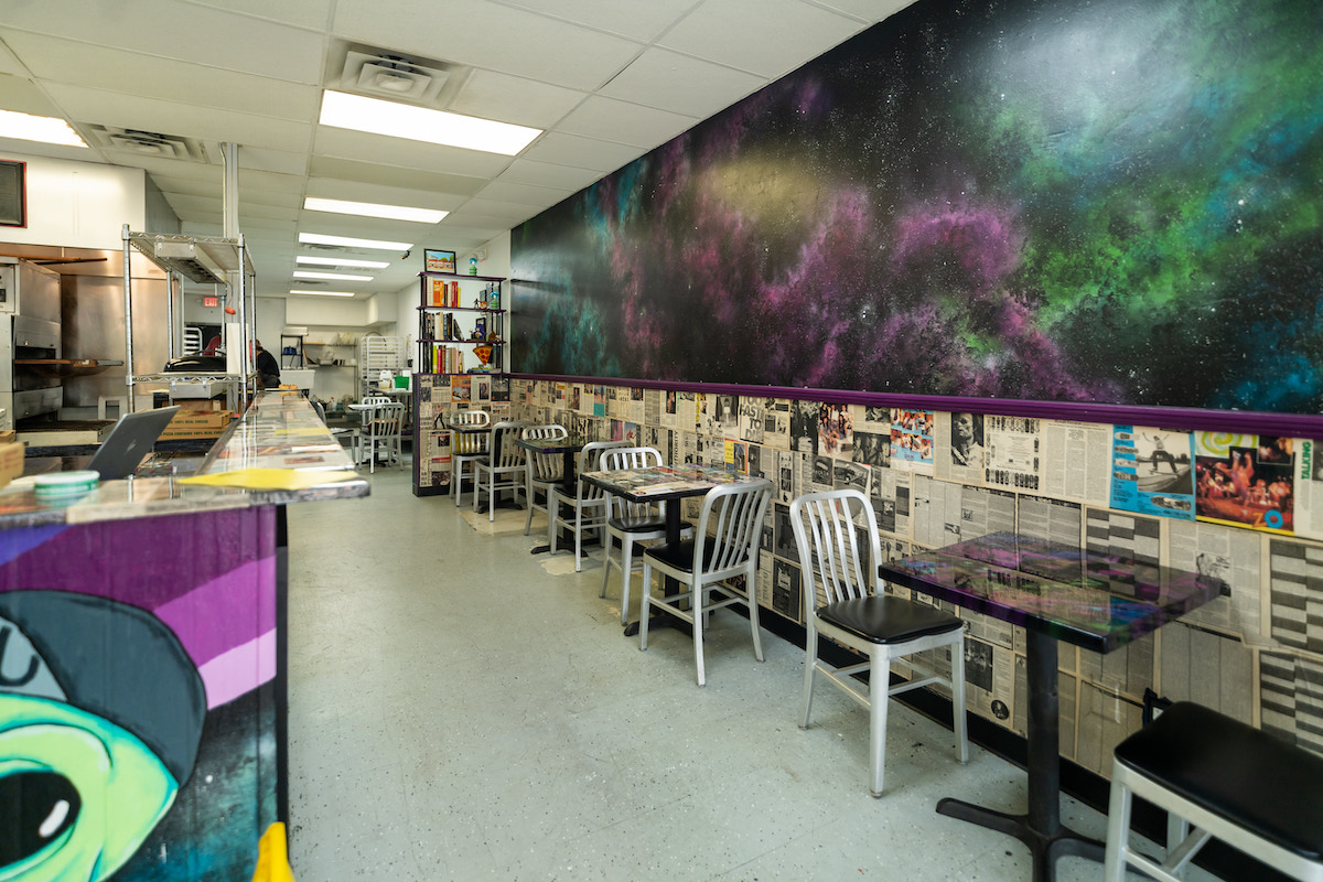 A colorful galaxy mural by artist Brian Dibala of Neon Thrash sets the tone inside Galaxy Pizza, Anthony Calleo's new retro-inspired neighborhood pizzeria in Spring. | Photo by Rebekah Flores