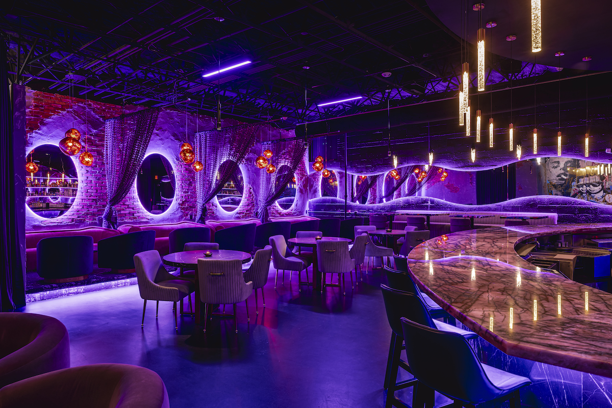Purple lighting, sculptural design, and plush seating give Punk Noir's lounge a dramatic atmosphere that feels equal parts cocktail bar, art gallery, and nightlife destination. | Photo by Samantha Marie Photography