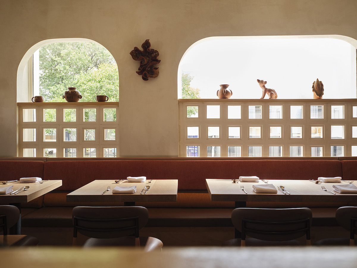 Warm earth tones, handcrafted ceramics, and natural light create an intimate dining room at Olōyō, inspired by the landscapes and traditions of Colima, Mexico. | Photo by Elizabeth Lavin