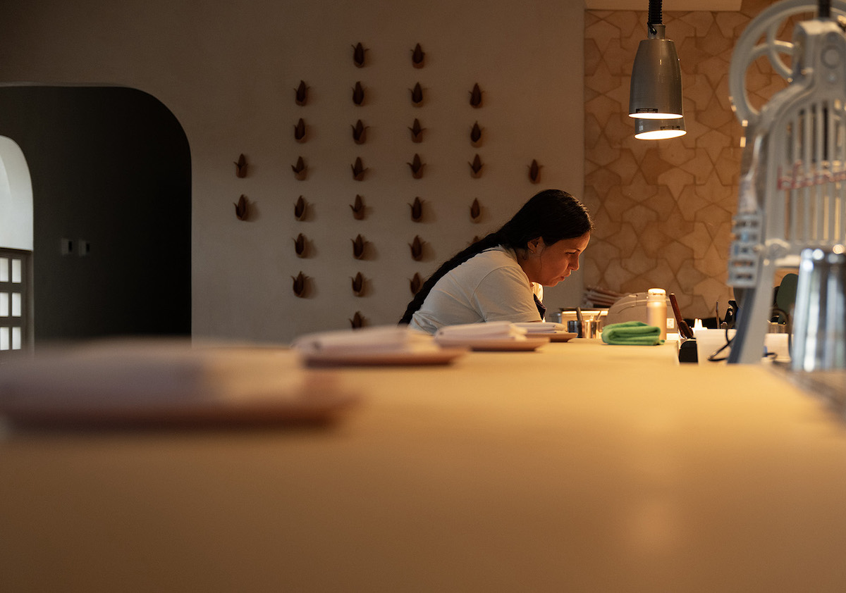 Oloyo_OliviaLopez_PhotobyElizabeth Lavin - DiningOut Chef Olivia López puts the finishing touches on dishes at Olōyō, her long-awaited 23-seat restaurant in Old East Dallas. | Photo by Elizabeth Lavin