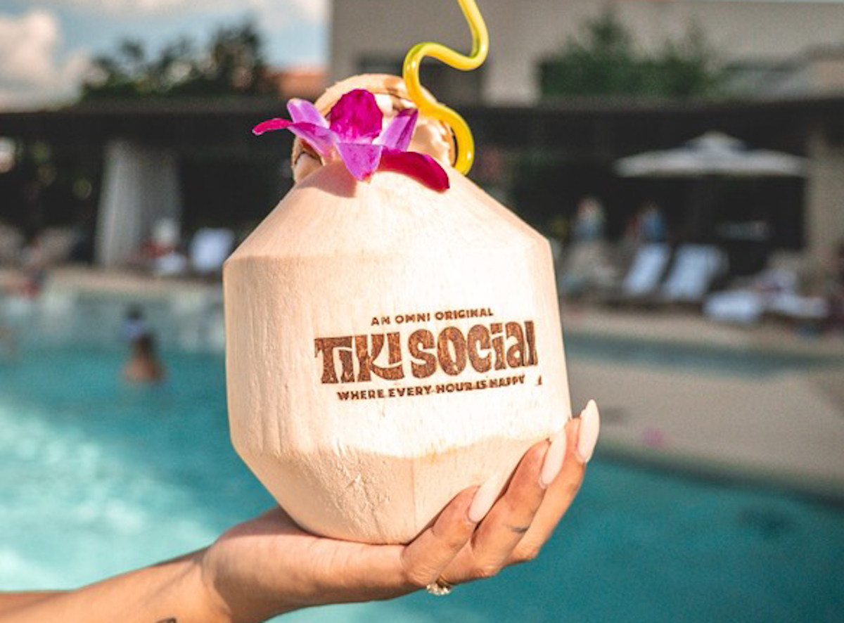 The Coconutty Islander, made with Myers’s Platinum Rum, passion fruit liqueur, coconut water, lime, and macadamia liqueur, is served in a fresh coconut as part of Omni Las Colinas' Tiki Social experience. | Photo by Visit Irving