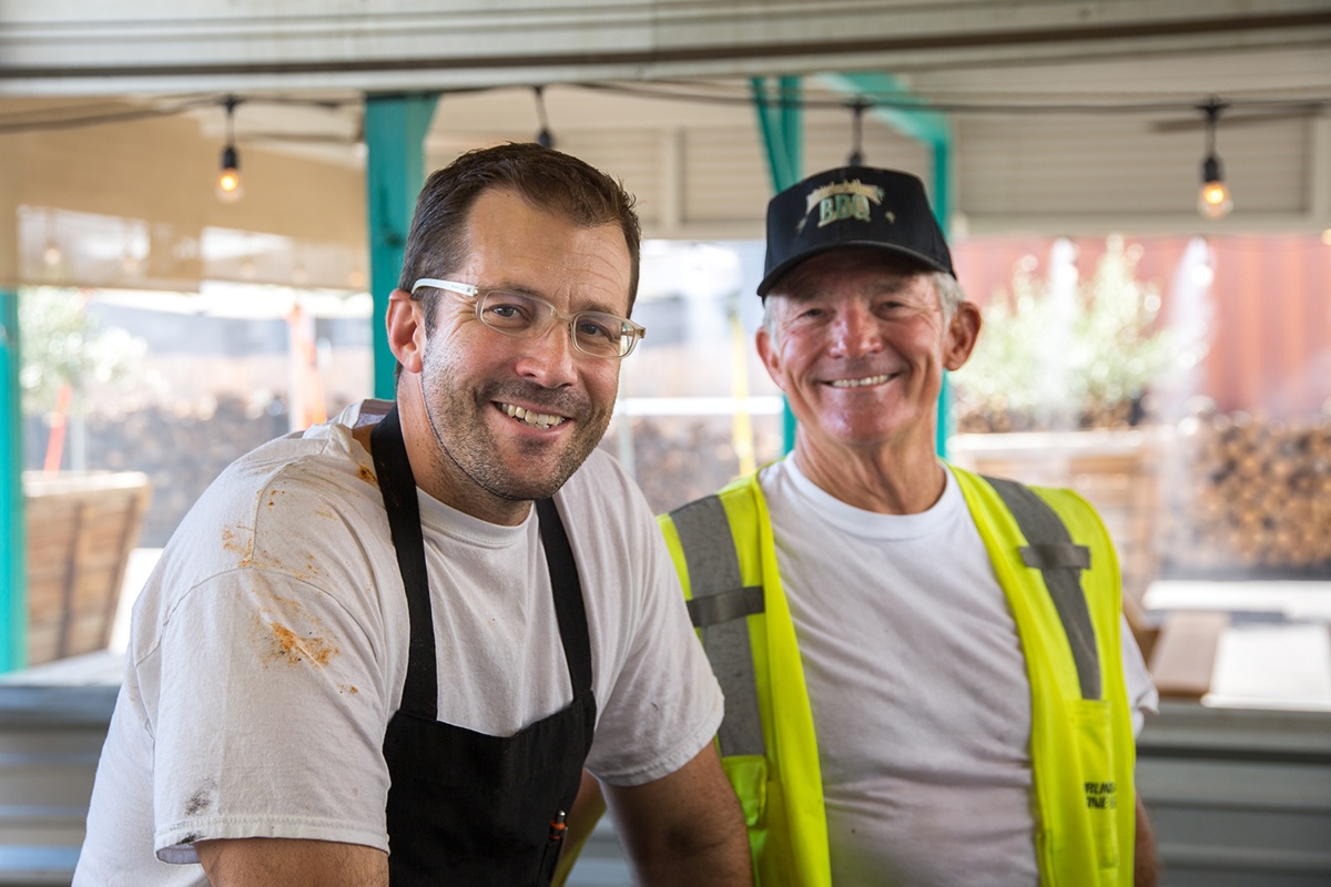 PHX_Little_Miss_BBQ_Scott Holmes and his father Denman - DiningOut Owner Scott Holmes and his dad working the pit. | Photo courtesy of Little Miss BBQ