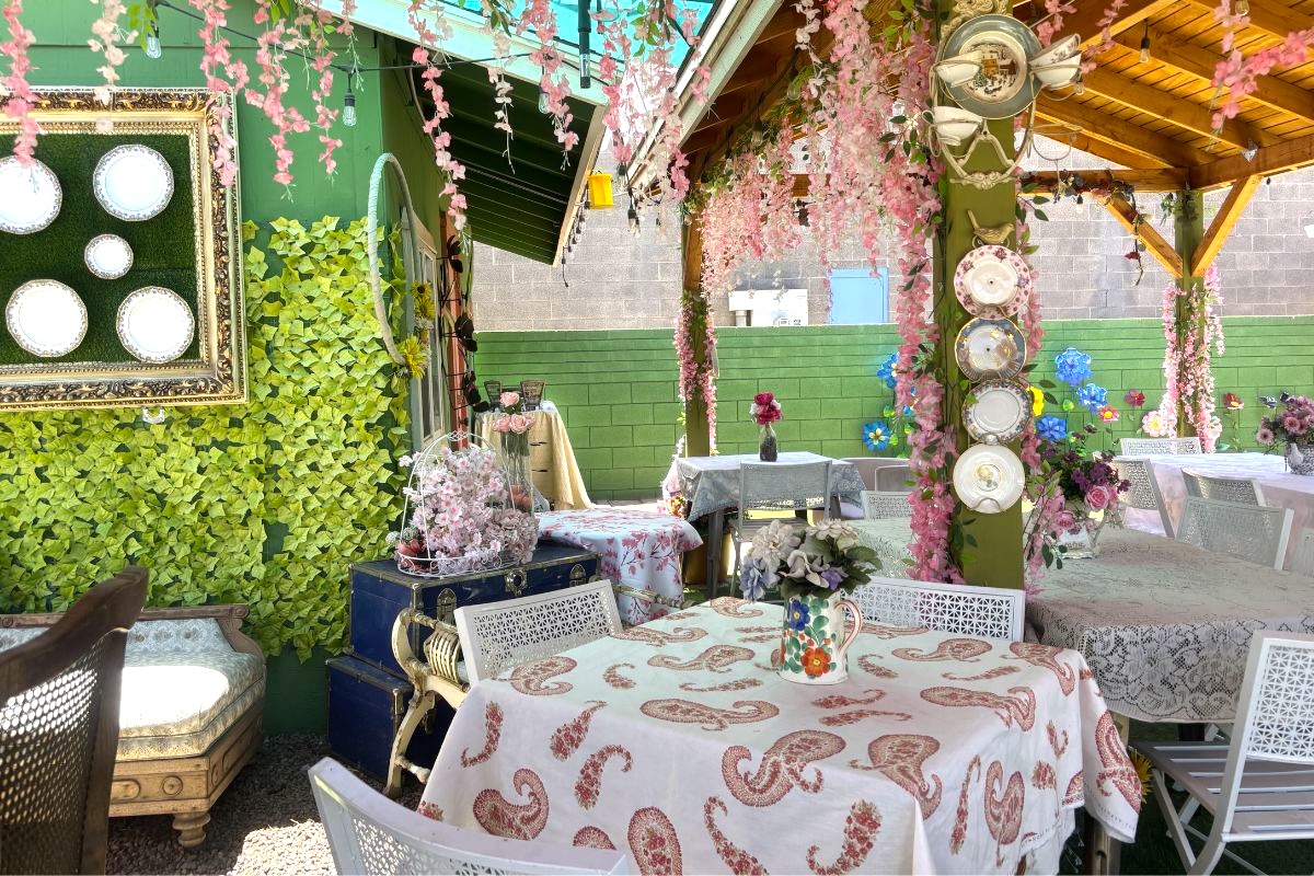 Sip tea in a room filled with pink flowers. | Photo by Kris Ann Valdez