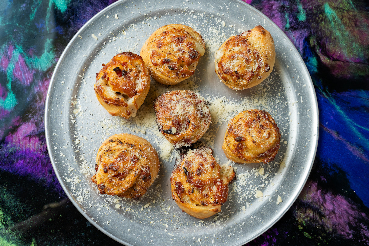 Galaxy Pizza's house-made pizza rolls are baked until golden brown and finished with grated cheese. | Photo by Rebekah Flores