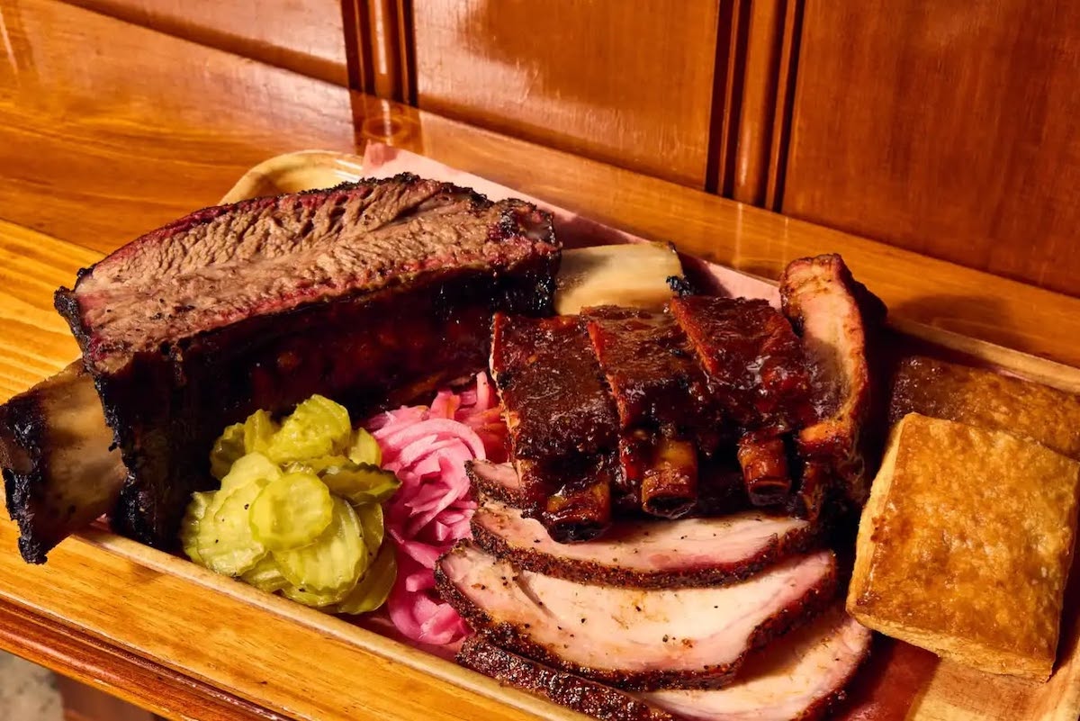 A packed platter at Pinkerton's BBQ, with pork and beef ribs, smoked turkey, and accompaniments. | Photo by Pinkerton's BBQ