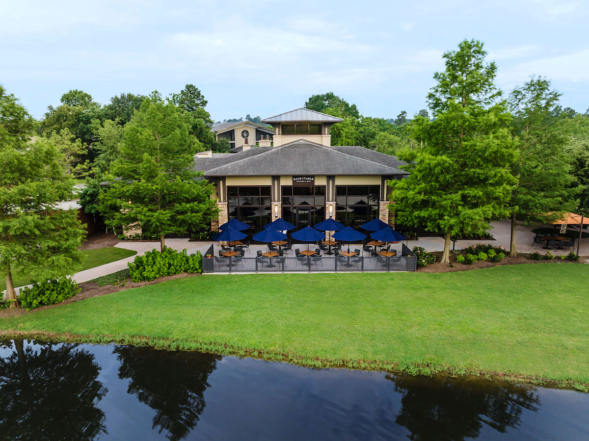 TWR-Back Table Drone - DiningOut Lush environs surround the patio at Back Table Kitchen & Bar in the Woodlands. | Photo by the Woodlands Resort