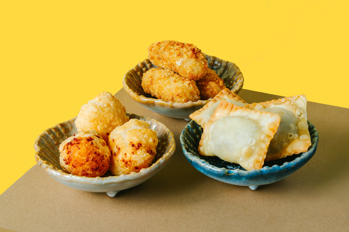Yuma's shareable snacks include pão de queijo, croquetas, and beef-filled pastéis, highlighting Brazilian comfort-food traditions. | Photo by Rebekah Flores
