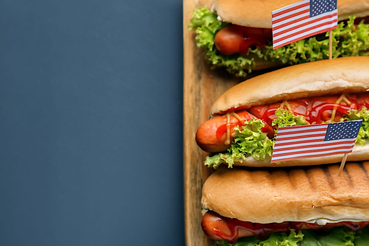 Tasty hot dogs with American flags on board