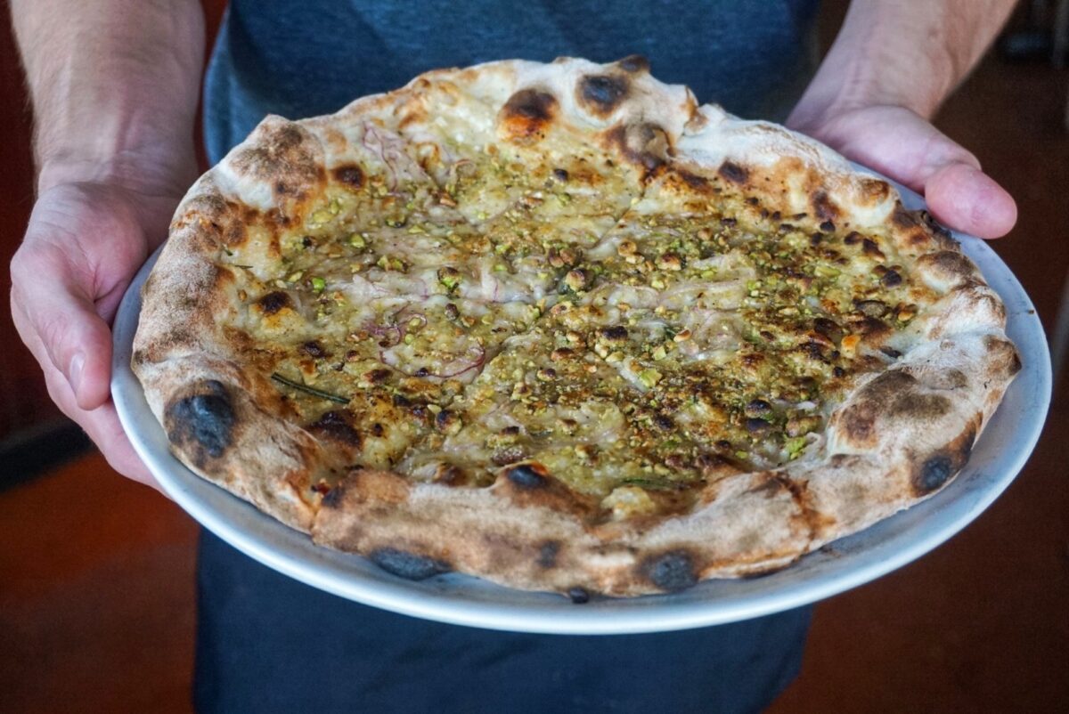 The Rosa, topped with red onion, parmigiano reggiano, rosemary, and Arizona pistachios. | Photo courtesy of Pizzeria Bianco