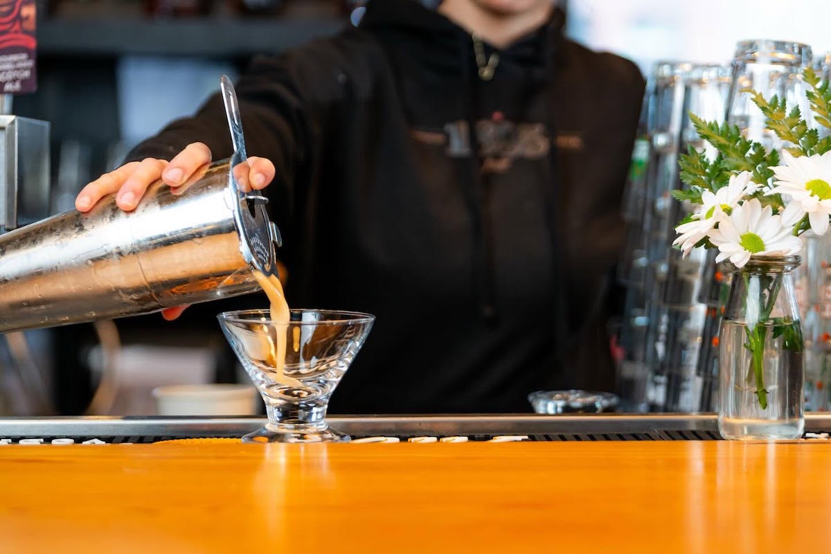 A bartender prepares one of 1885 Grill's handcrafted cocktails, part of a beverage program that complements the restaurant's Southern-inspired menu and regular community events. | Photo by 1885 Grill