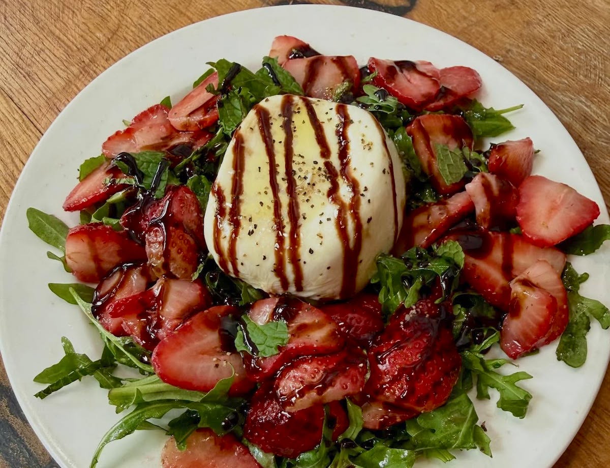 Seasonal dishes, including this strawberry burrata salad, reflect 1885 Grill's approach to fresh ingredients and menu items shaped by customer feedback. | Photo by 1885 Grill