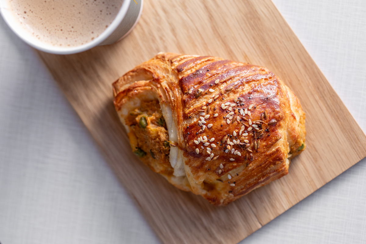 The Chai Box Cafe's signature samosa croissant combines buttery, flaky pastry with a warmly spiced potato filling inspired by the classic Indian snack. | Photo by Kate Blohm