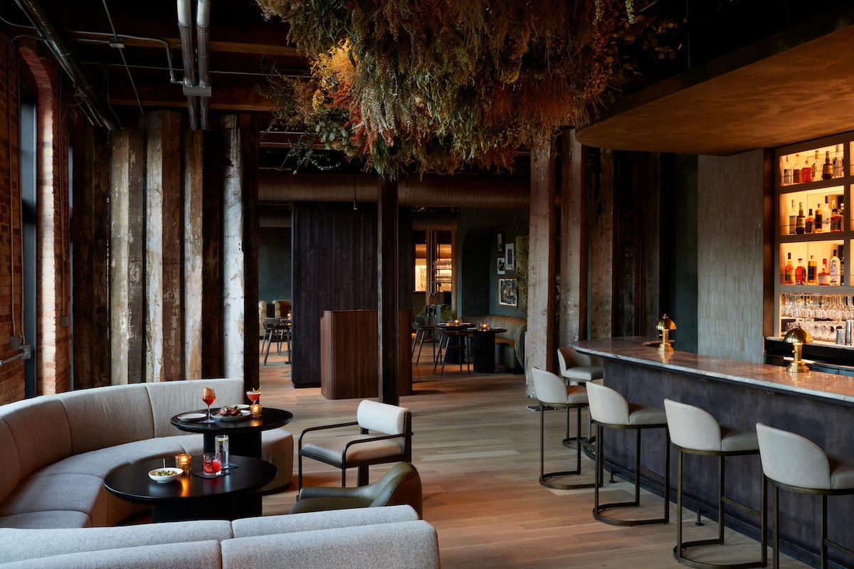 The stylish bar at Osteria Olio inside Rivet House pairs a sophisticated cocktail program with an impressive selection of amari in a warm, design-forward setting. | Photo by Rivet House