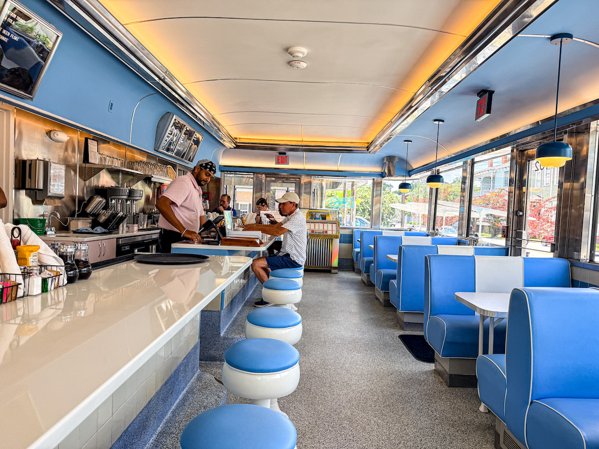 Retro blue booths, counter seating, and vintage jukebox vibes transport diners back to the golden age of American diners at Bobbie's Diner. | Photo by Sarah Bisacca
