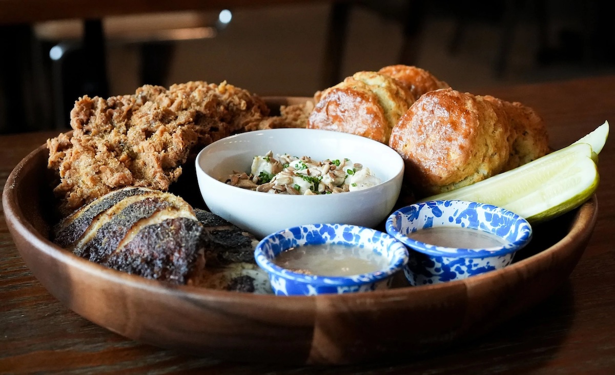 Brochu's Family Tradition serves a family-style feast featuring chamomile-brined fried chicken, housemade biscuits, smoked fish dip, and thick slices of cornbread. | Photo by Brochu's Family Tradition