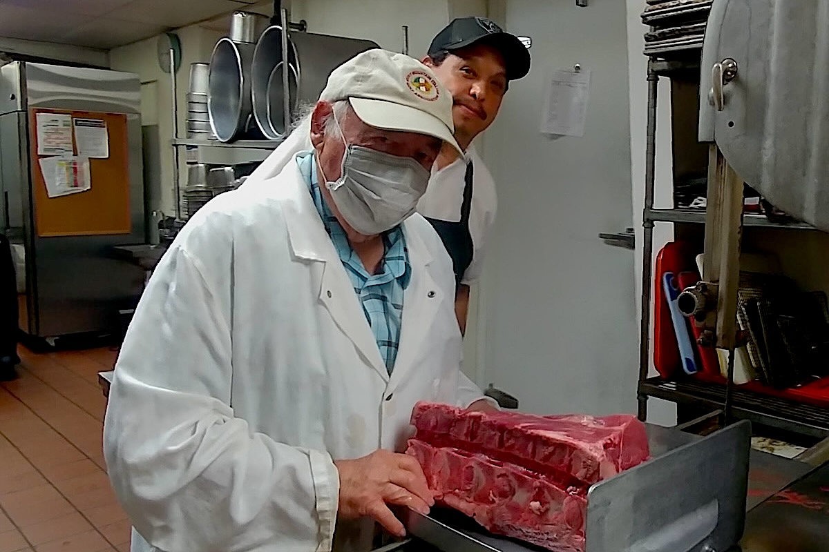 DEN_Mickey_cutting_steak_with_chef_Jesus_Melendez - DiningOut Even after he sold the restaurant, Mickey Broncucia cut all the steaks. | Photo courtesy of Micky's Top Sirloin