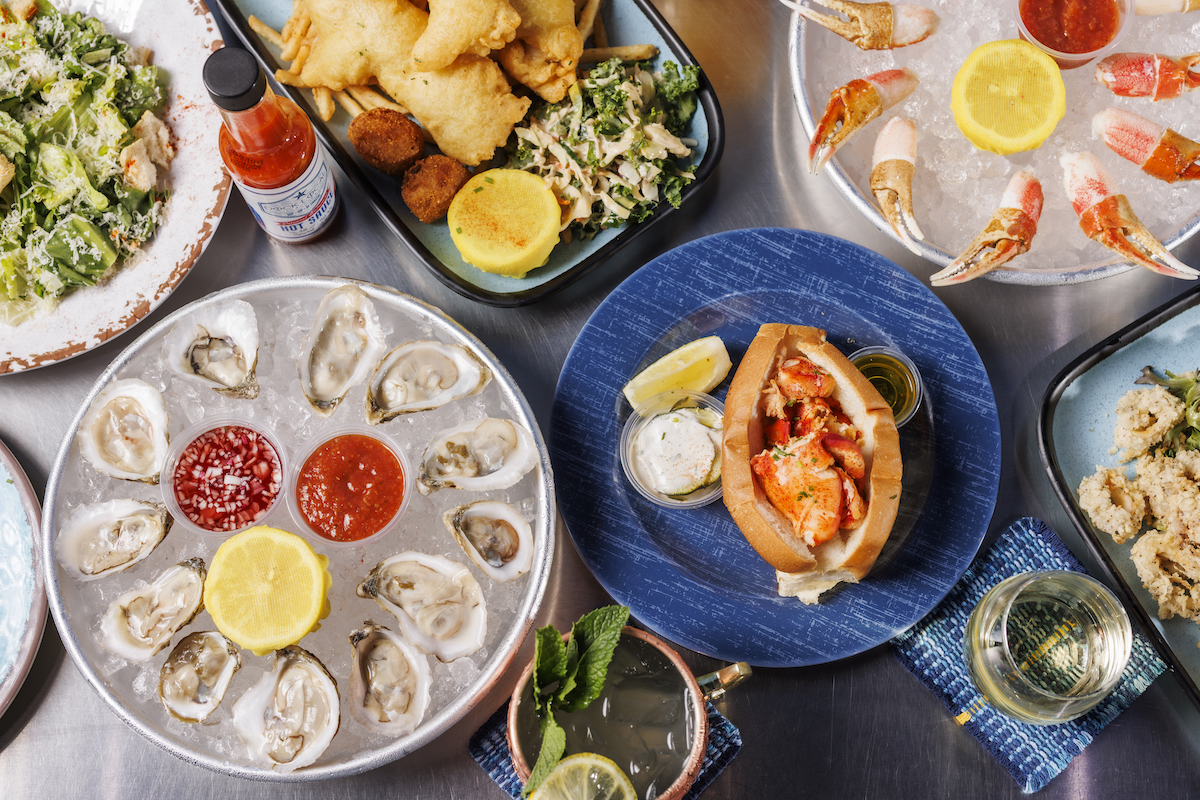 Dock Local - DiningOut A spread of Dock Local's signature coastal dishes. | Photo by Samantha Marie Photography