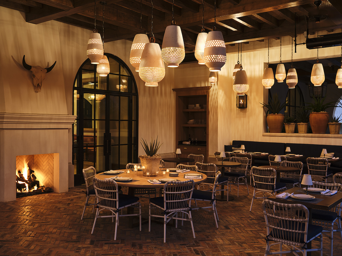 A fireplace, handcrafted lighting, and layered textures make Latuli's dining room as much a destination as the ingredient-driven menu served within. | Photo by Frank Frances