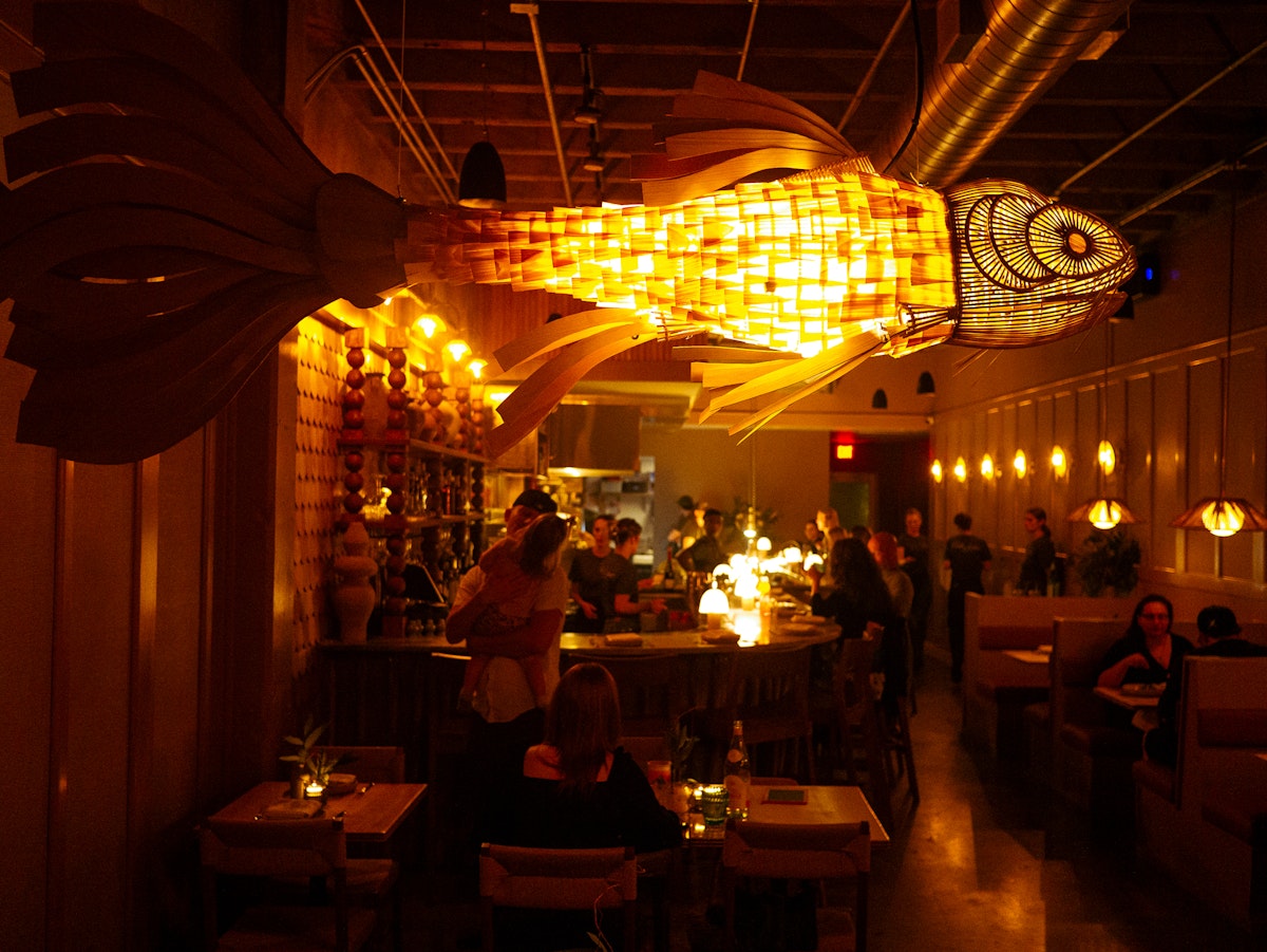 Fishbar's bustling dining room pairs a relaxed neighborhood atmosphere with a seafood-focused menu cooked over a live wood fire. | Photo by Fishbar