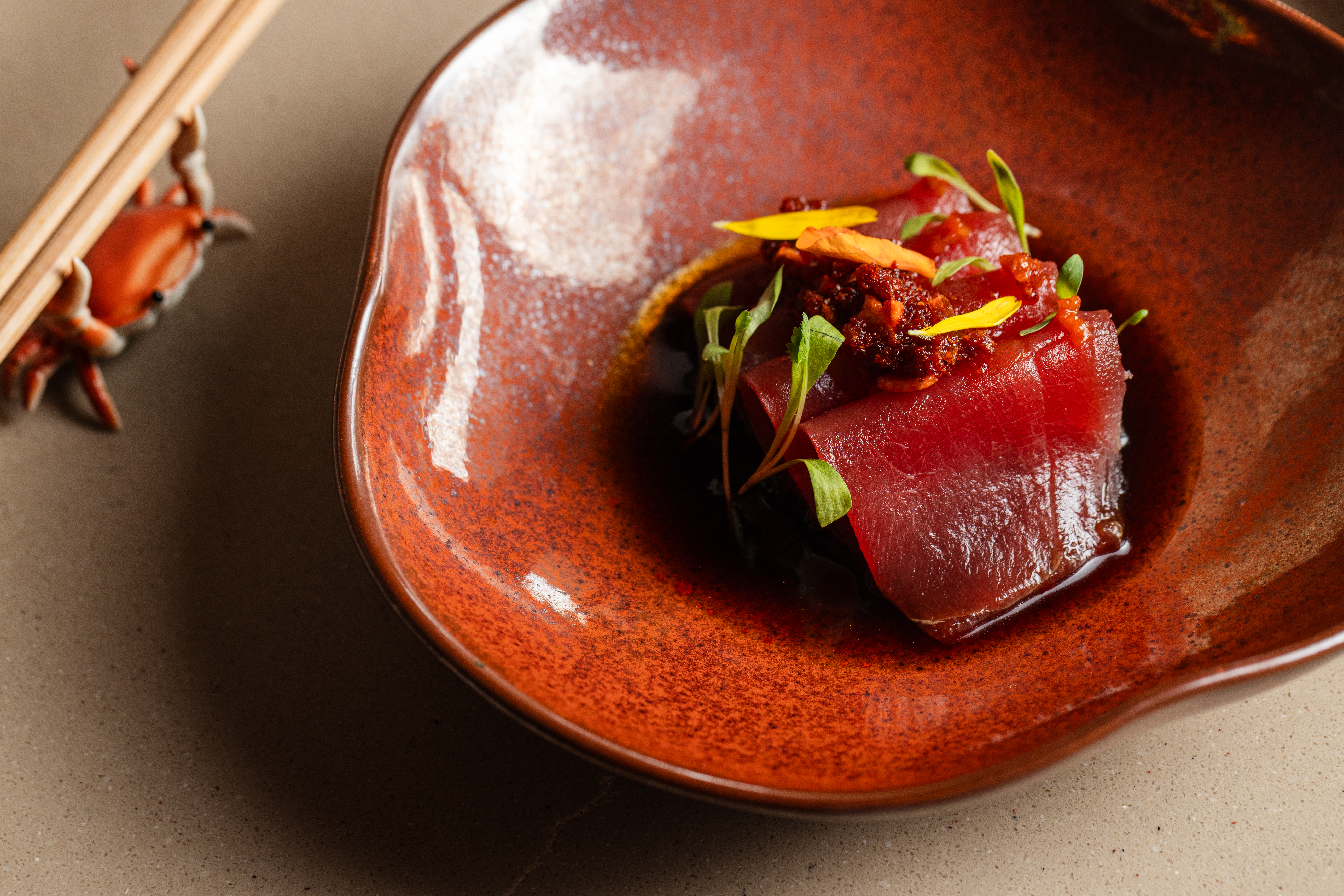 KOYO's crudo showcases fresh seafood with minimalist presentation, letting premium ingredients take center stage. | Photo by Becca Wright
