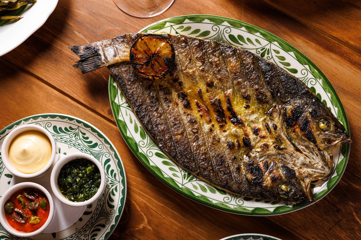 Chef Stefano Secchi does a whole grilled fish at Massara. | Photo by Alex Staniloff
