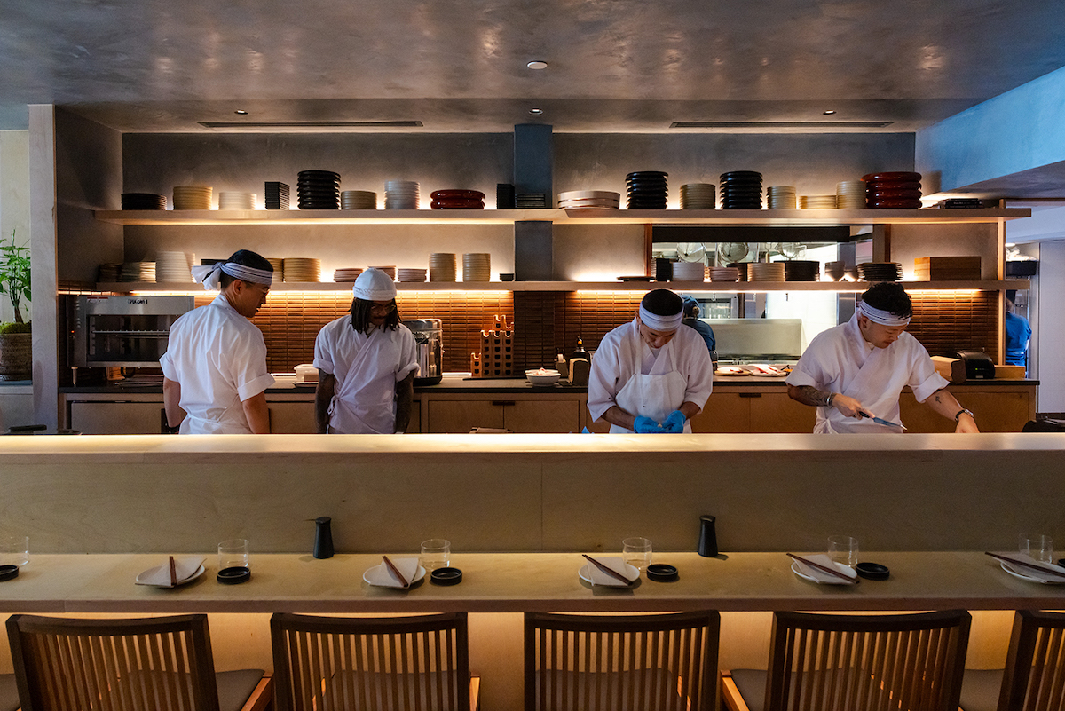 Chefs prepare sushi behind the open kitchen counter at Neighborhood Sushi's first Dallas location. | Photo by Justin Cook