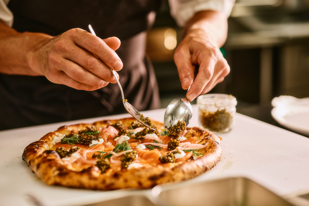 Scilla - DiningOut Scilla's Ossetra caviar pizza is finished with generous spoonfuls. | Photo by Chase Hall