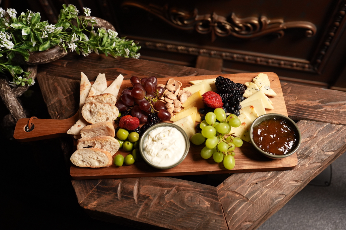 A selection of imported cheeses, fresh fruit, house accompaniments and warm bread sets the tone for an evening of leisurely sipping and sharing at Otium. | Photo by Otium
