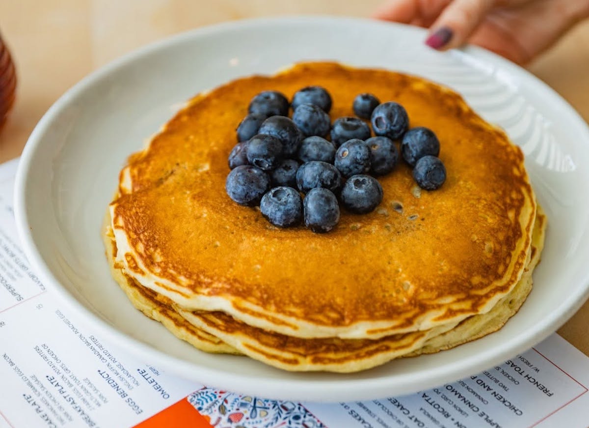Pancake Social's fluffy buttermilk pancakes, served with fresh blueberries. | Photo by Pancake Social