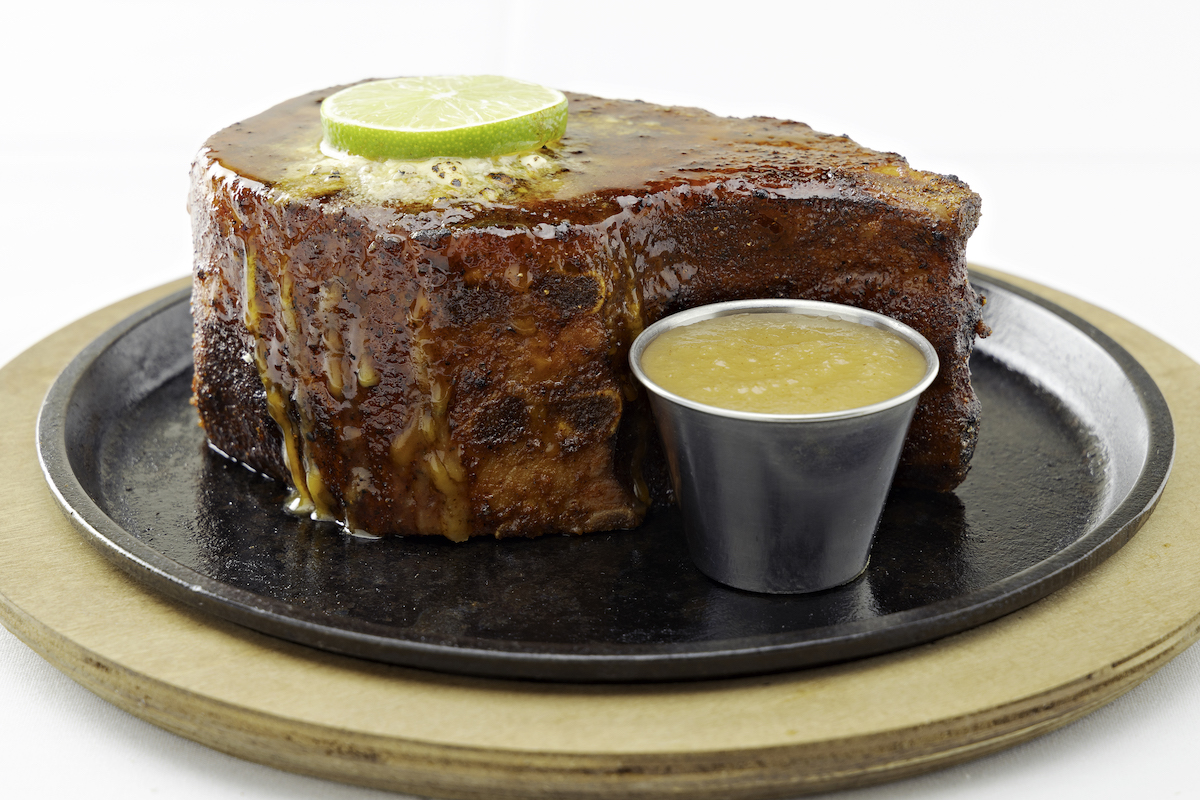 Perry's Steakhouse - DiningOut Perry's famous pork chop is featured on the steakhouse's limited-time $44 four-course anniversary menu. | Photo by Perry's Steakhouse & Grille