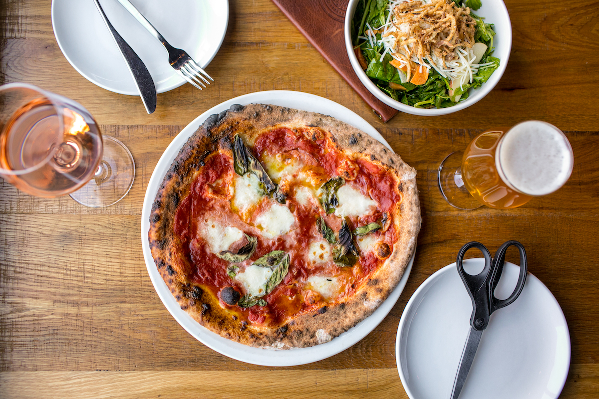 Double Zero's classic Margherita pizza showcases the restaurant's signature three-day fermented dough, San Marzano tomatoes, fior di latte, and basil—proof that great pizza doesn't need an endless list of toppings. | Photo by Heidi Harris