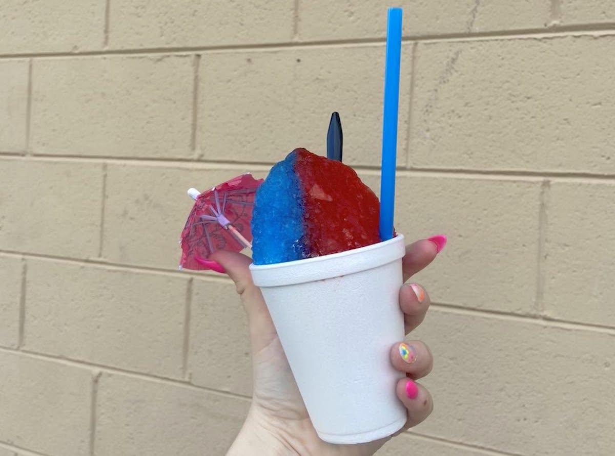 Polar Penguins - DiningOut A split sno-cone showcasing two flavors at Polar Penguin's Snowcones. | Photo by Polar Penguin's Snowcones