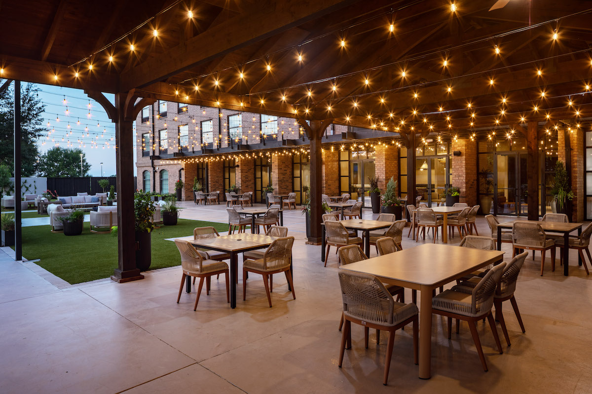 The Clara Hotel's inviting courtyard offers an open-air gathering space for guests enjoying drinks from Archer or dinner at Field & Vine. | Photo by Greg Ceo Studio