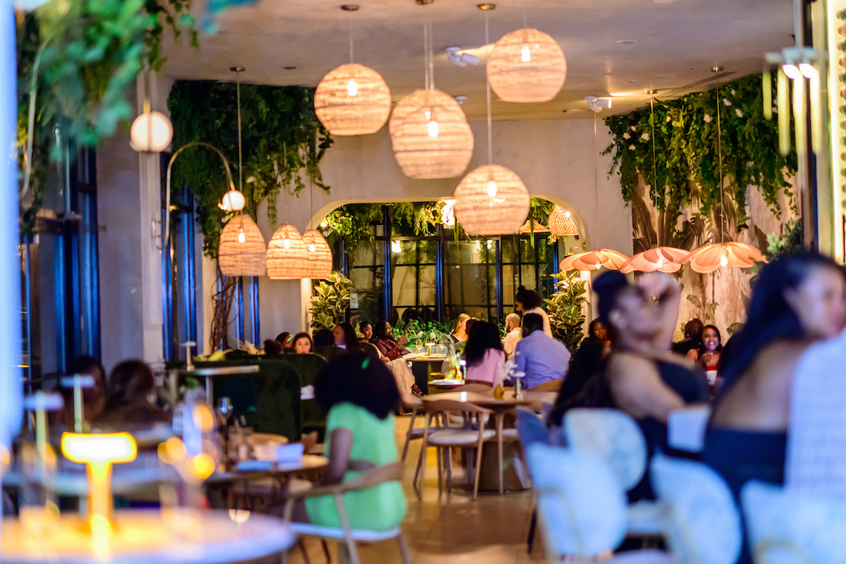 Verdure Kitchen & Cocktails pairs lush, greenery-filled interiors with a menu inspired by West African and French flavors, creating a stylish dining destination just minutes from Piedmont Park. | Photo by Verdure Kitchen