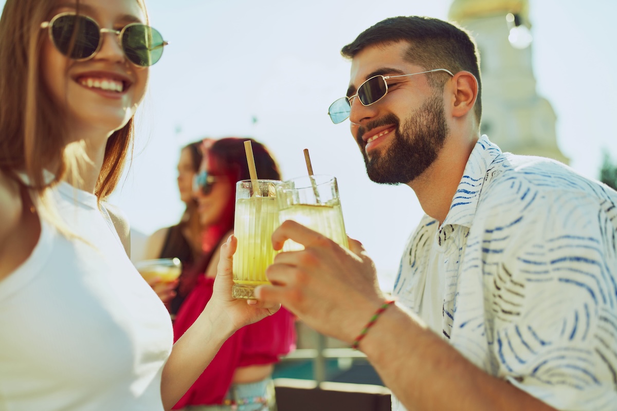 Lively outdoor gathering features friends toasting with colorful cocktails, enjoying each others company. Concept of party, Friday mood, celebration, summer holidays, relax. day drinking cocktails new york
