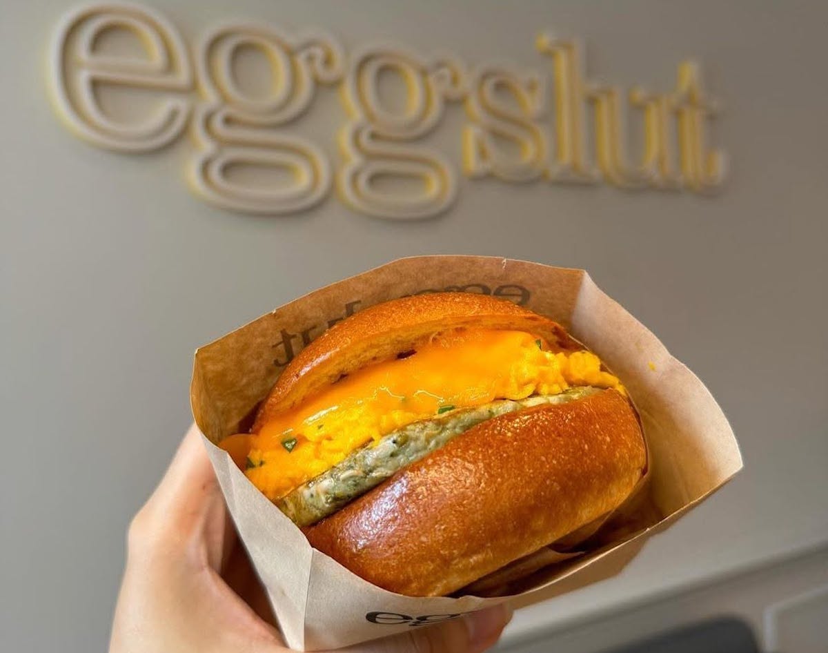 Eggslut's signature Fairfax sandwich, made with soft scrambled eggs, cheddar, caramelized onions, and sriracha mayo on a warm brioche bun. | Photo by Eggslut