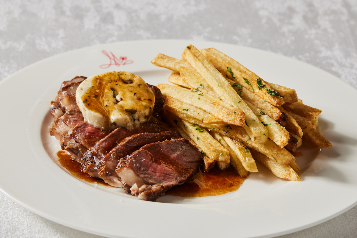 Steak frites at Brasserie Margot pairs Black Angus sirloin with crispy house-made fries and plenty of sauce. | Photo by Kathryn McCrary