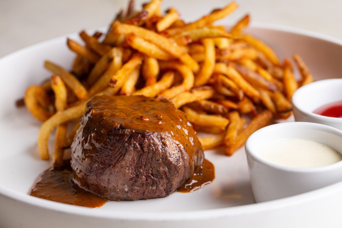 Brasserie 19 serves a classic steak frites with a prime cut of beef, crisp pommes frites and a peppery au poivre sauce. | Photo by Andrew Hemingway