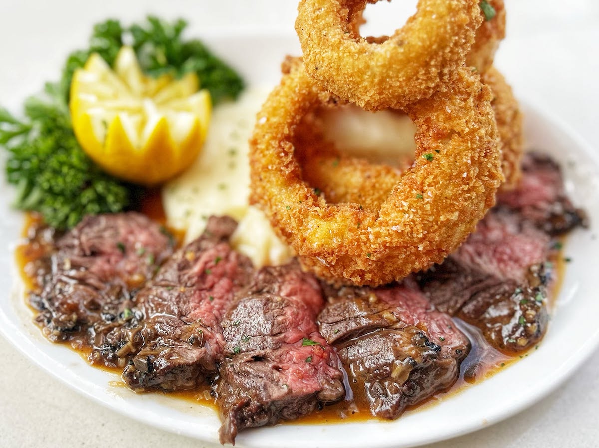 Better Luck Tomorrow’s Wednesday steak night pairs bistro steak with potato purée, thick-cut onion rings, and truffle gravy. | Photo by Better Luck Tomorrow