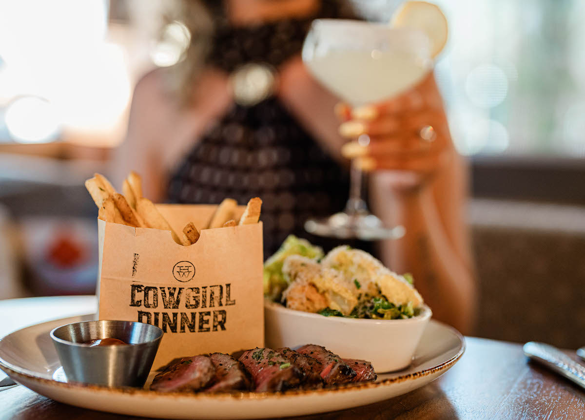 Cowgirl Dinner at Haywire pairs a 5-ounce steak with Caesar salad, crispy tallow fries, and a choice of cocktail for $30 through August 31. | Photo by Melissa Chu
