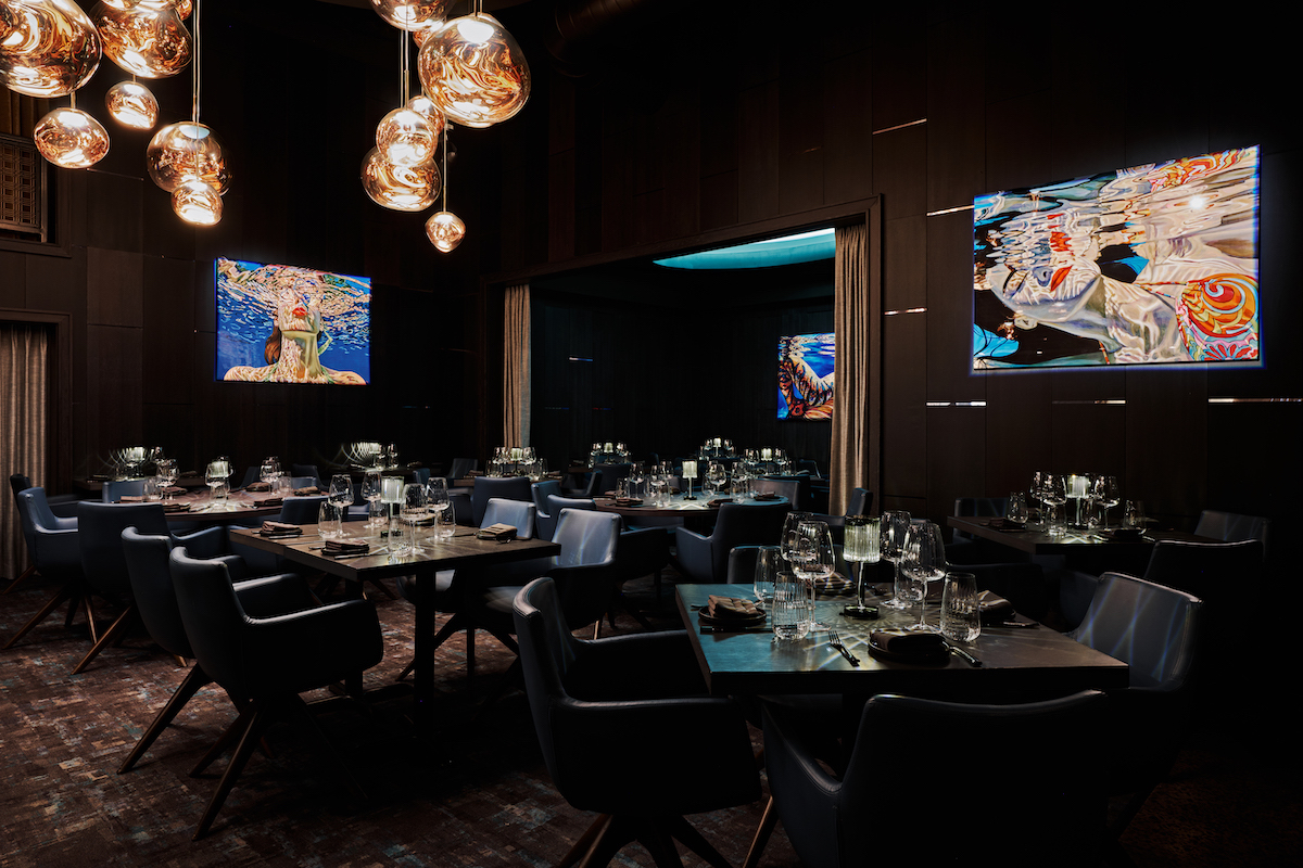 Siren - DiningOut Siren’s intimate 80-seat dining room draws inspiration from the sea caves of the Italian coast, with glowing Tom Dixon fixtures and custom mermaid artwork. | Photo by Andrew Thomas Lee