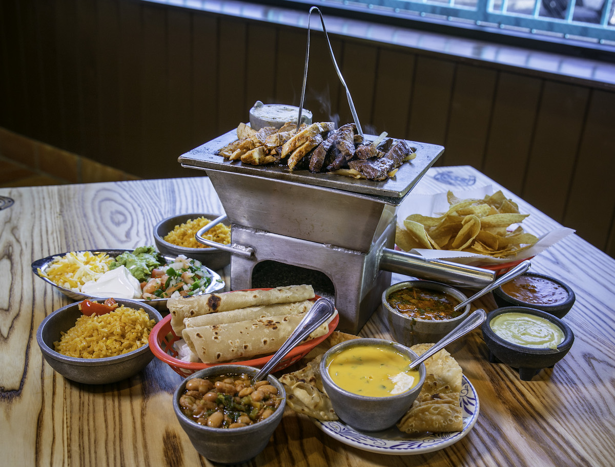 El Tiempo Cantina keeps the Laurenzo family’s fajita tradition alive with sizzling beef and chicken served alongside tortillas and all the fixings. | Photo by Kelley Sweet Photography