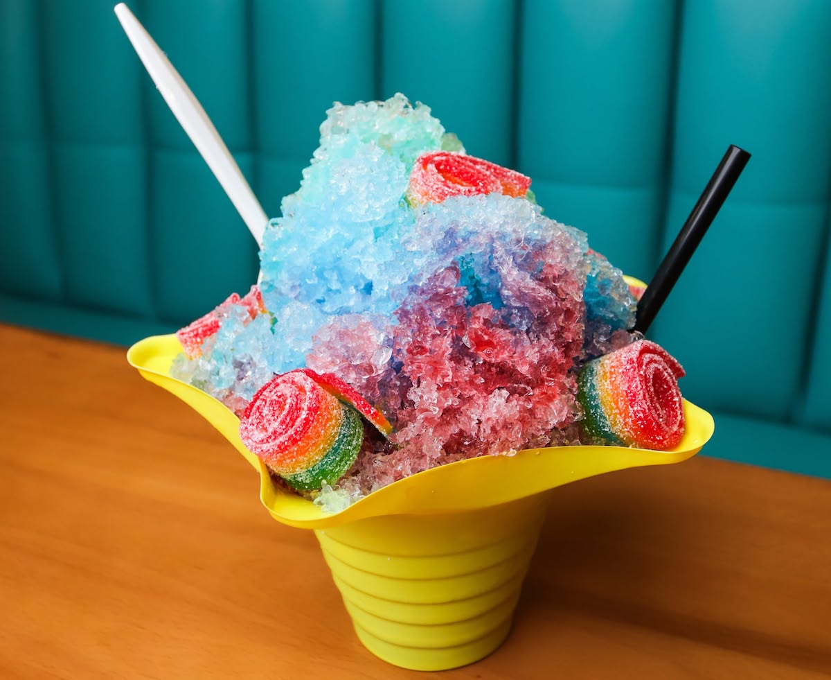 A colorful shaved ice creation at Gaspachos is piled high and finished with sour gummy candy for an extra-sweet summer treat. | Photo by Gaspachos