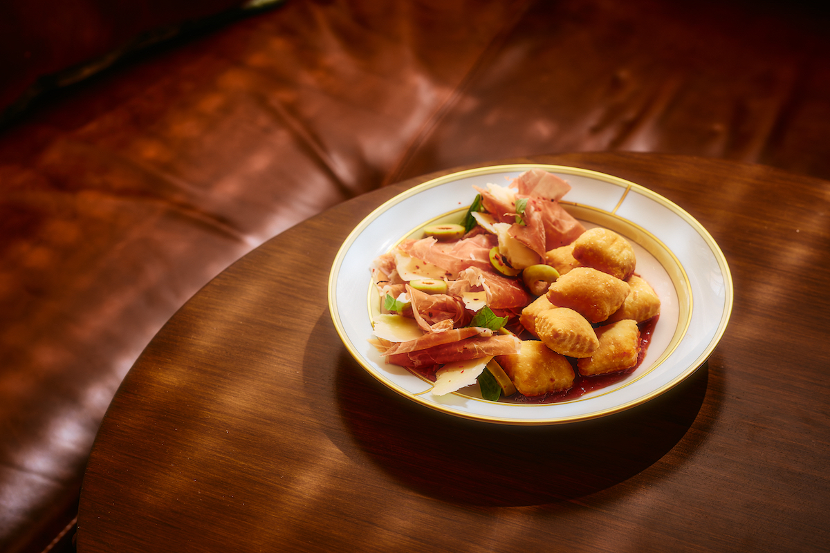 Pillowy gnocco fritto is paired with prosciutto, cheese, olives, and fresh herbs. | Photo by Chase Hall