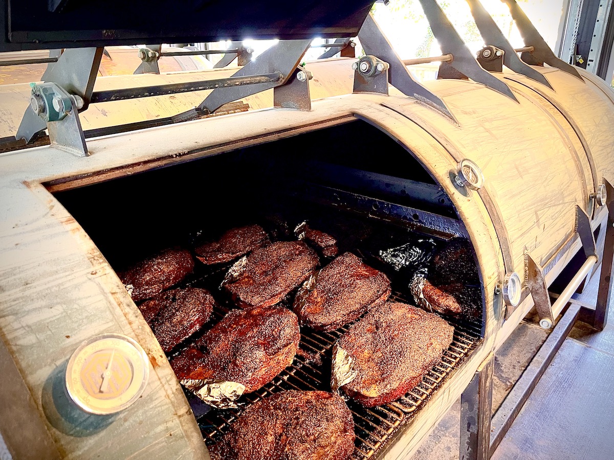 Briskets develop their signature dark bark while smoking low and slow over post oak at Terry Black’s Barbecue. | Photo by Greg Morago