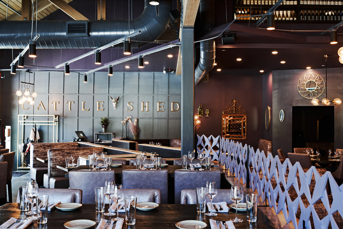 Cattle Shed - DiningOut Cattle Shed’s polished dining room blends contemporary steakhouse style with warm wood details and industrial accents. | Photo by Cattle Shed