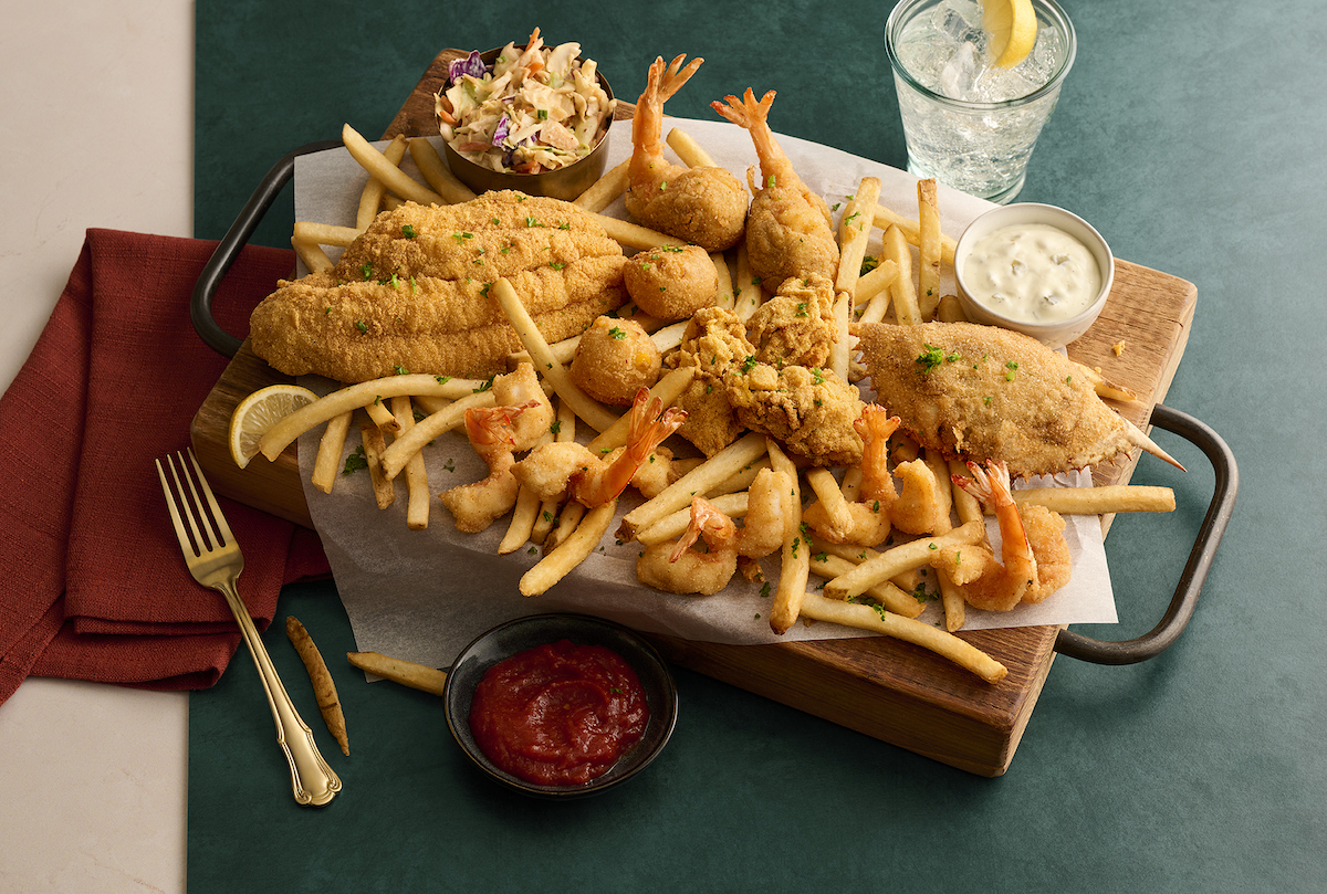 Landry’s Seafood House serves up a Gulf Coast feast with fried fish, shrimp, crab, stuffed shrimp, hush puppies, fries, and coleslaw. | Photo by Landry's